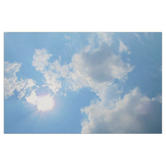 Vibrant blue sky with sun and clouds photo fabric