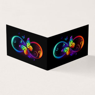 Vibrant infinity with rainbow butterfly on black business card