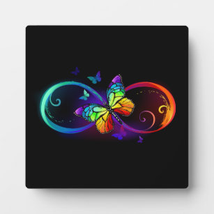 Vibrant infinity with rainbow butterfly on black plaque
