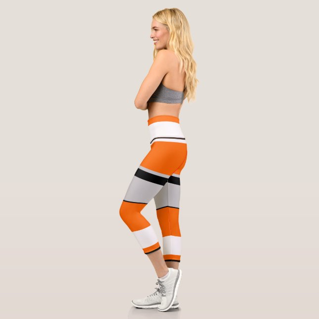 Vibrant Orange, White, Black, and Ash Striped Capri Leggings (Left)