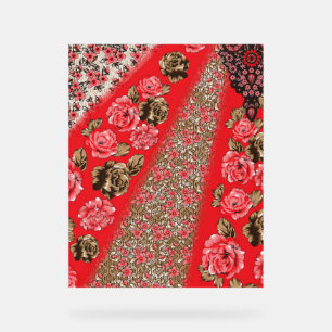 Vibrant red fabric featuring intricate floral and  acrylic sign