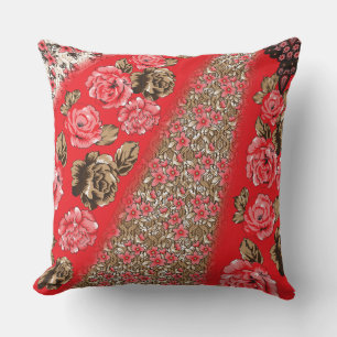 Vibrant red fabric featuring intricate floral and  cushion