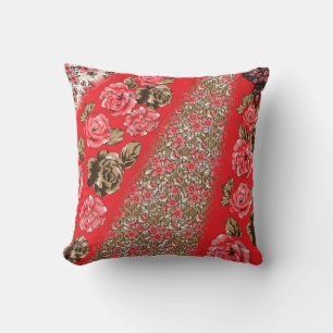 Vibrant red fabric featuring intricate floral and  cushion