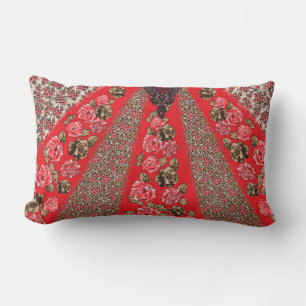 Vibrant red fabric featuring intricate floral and  lumbar cushion