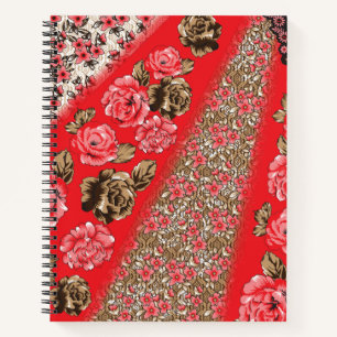 Vibrant red fabric featuring intricate floral and  notebook