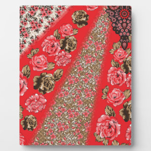 Vibrant red fabric featuring intricate floral and  plaque