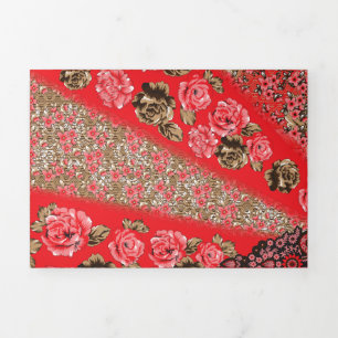 Vibrant red fabric featuring intricate floral and Tri-Fold invitation