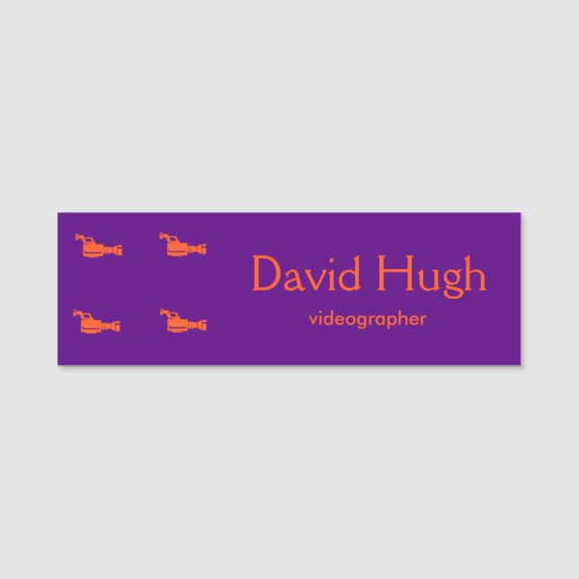 Video camera orange silhouette purple name tag (Front)