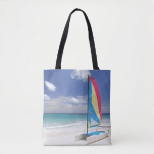 View Of Beach With Sailboat Tote Bag