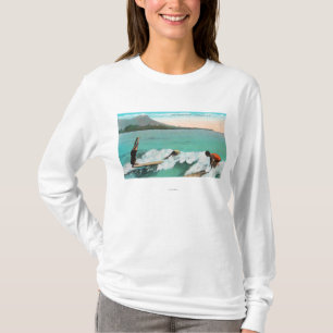 View of Surfers Board Riding, One Taking a T-Shirt
