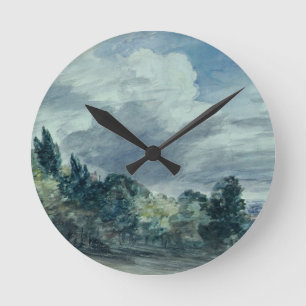 View over a wide landscape, with trees in the fore round clock