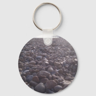 View over pebbles to silouetted West Pier Key Ring