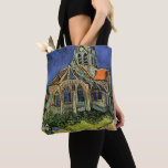 Vincent van Gogh - The Church at Auvers Tote Bag<br><div class="desc">The Church at Auvers (1890) by Vincent van Gogh is a vintage Post Impressionism fine art architectural religious painting. A woman walking along a path towards the village chapel with beautiful stained glass windows. A daily life architecture scene. About the artist: Vincent Willem van Gogh (1853-1890) was a Post Impressionist...</div>