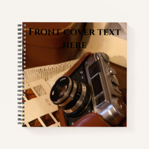 Vintage analogue camera in leather brown case notebook