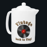 Vintage - Back to Vinyl, the record is back<br><div class="desc">The design features a stylised black vinyl record with realistic grooves and a glossy effect. The middle label is red and contains the words “50s, 60s, 70s, 80s, 90s” arranged in a circle around the middle - a homage to the musical decades. Above the record, the word “Vintage” is shown...</div>