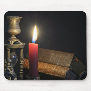 Vintage books and hourglass on dark background mouse pad