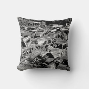 Vintage cars rusting away in a car yard cushion