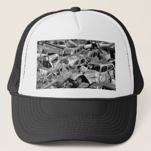 Vintage cars rusting away in a car yard trucker hat