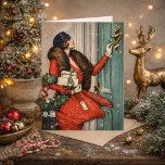 Vintage Christmas Doorstep Illustration Card<br><div class="desc">Celebrate the charm of a classic winter holiday with this beautiful vintage-style illustration featuring an elegant woman in a vibrant red coat delivering festive gifts. Holding a holly wreath and ringing a doorbell in the snow, this nostalgic scene captures the warmth and sophistication of early 20th-century holiday fashion and seasonal...</div>