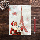 Vintage Eiffel Tower, Santa, Paris Christmas Holiday Card<br><div class="desc">This beautiful vintage Christmas card design features an elegant light background with poinsettia flowers,  the Eiffel Tower and Santa Claus holding a gift.  Easily personalise the inside of this vintage styled card with a holiday message.</div>