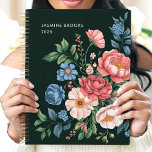 Vintage Garden Botanical Custom Name Floral Planner<br><div class="desc">This exquisite design showcases a lush arrangement of vintage-inspired garden blooms in pink, blue, cream, and coral hues, set against a deep green background. Personalised with a custom name and the year 2025, it offers timeless elegance and sophistication. Perfect for nature enthusiasts, garden lovers, or anyone drawn to classic floral...</div>