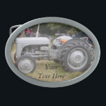 Vintage Grey massey fergison tractor Oval Belt Buckle<br><div class="desc">The original photograph of this old vintage tractor on this belt buckle was taken at the Epping forest Festival. The massey fergison grey tractor on this original buckle was used on farms many years ago. The tractor picture captures an image when farm machinery was a lot smaller than the massive...</div>