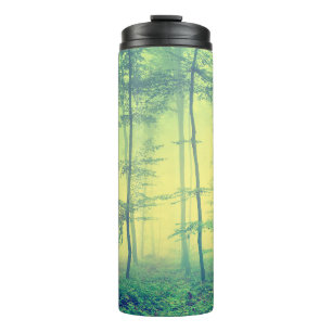 Vintage photo of foggy spring forest. thermal tumbler