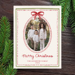 Vintage Red Bow Cream Christmas Photo Holiday Postcard<br><div class="desc">Share warm holiday greetings with this classic Christmas postcard featuring your family photo framed in a vintage watercolor oval design accented by a red bow and dotted border. “Merry Christmas” is displayed in handwritten red script, with your family name and year printed below. The cream background bordered in red and...</div>