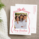 Vintage Red Bow Merry Christmas Photo Holiday Postcard<br><div class="desc">Celebrate the holiday season with this charming Christmas postcard featuring your family's photo framed by a festive red bow and ribbon on a crisp white background. "Merry Christmas" is elegantly written in a charming red handwritten script, with space to personalise your family name below. The back of the postcard displays...</div>