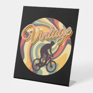 VINTAGE RETRO CYCLING IN COLORFUL TWIRL PEDESTAL SIGN