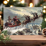 Vintage Retro Santa Claus Reindeer Sleigh Holiday Card<br><div class="desc">Vintage Retro Santa Claus Reindeer Sleigh Holiday Card. This design features Santa Claus guiding his reindeer sleigh through the night sky. What a beautiful retro holiday scene. Personalise this custom design with your own inside greeting.</div>