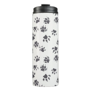 vintage seamless pattern with paw footprints of a  thermal tumbler