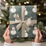 Vintage Snowmen on Sage Green  Wrapping Paper<br><div class="desc">Bring a touch of vintage charm to your holiday gifts with this Vintage Snowmen on Sage Green Wrapping Paper. Featuring adorable and realistic snowmen in a minimalist design, this neutral-coloured wrapping paper offers a soft, cosy feel with a modern twist. The subtle sage green background adds a calming, festive tone...</div>