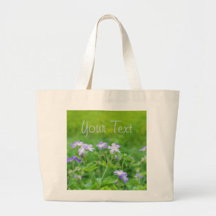 Violet flowers in the field large tote bag