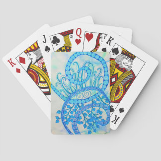 Vivid blue abstract spirals and plants playing cards