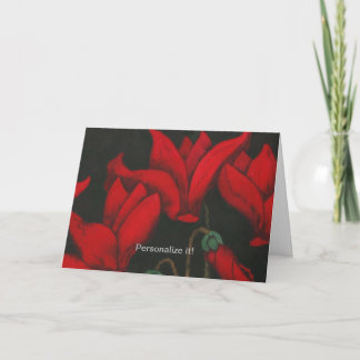 Vivid red Cyclamen blossom on dark black backgroun Card