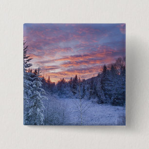 Vivid sunset paints the sky above wintery 15 cm square badge
