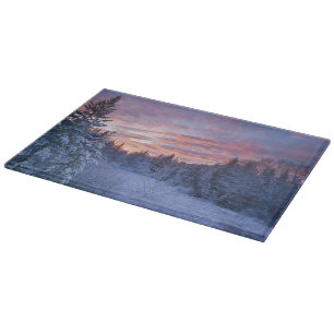 Vivid sunset paints the sky above wintery cutting board