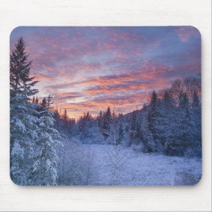 Vivid sunset paints the sky above wintery mouse pad