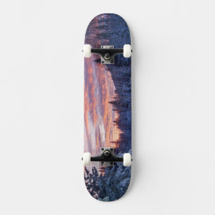 Vivid sunset paints the sky above wintery skateboard