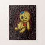 Voodoo Rag Doll Jigsaw Puzzle<br><div class="desc">Spooky but cute voodoo rag doll made from sackcloth,  with a patch on his head,  one button eye and a sad stitched mouth. A red heart shaped patch on his chest has two pins sticking in. The background is a peeling paint effect.</div>