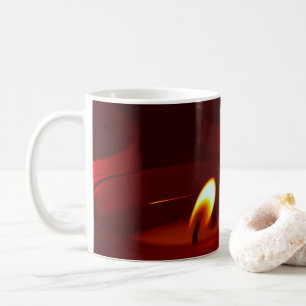 Votive candles burning in vigil coffee mug