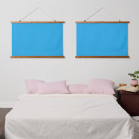 A blue square framed by a white border, presenting