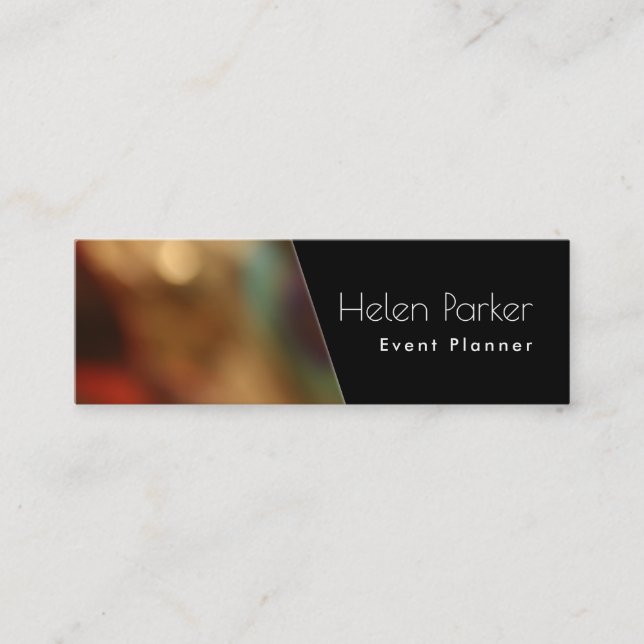 Warm, blurred photo beside solid black diagonal mini business card (Front)