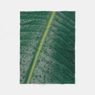 Water droplets on banana leaf fleece blanket