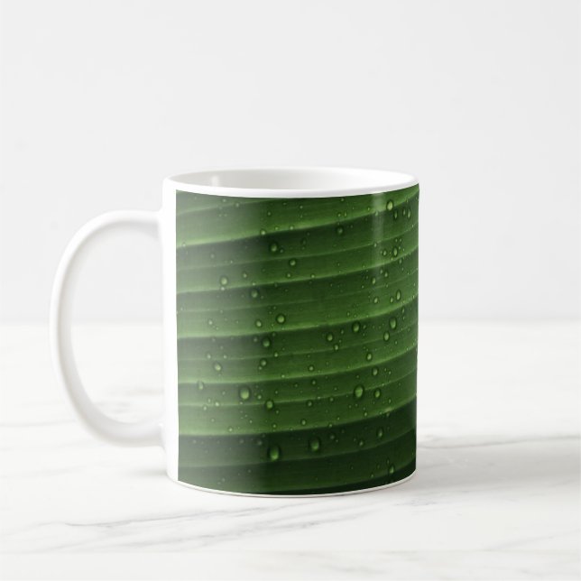 Water droplets on green leaf coffee mug (Left)