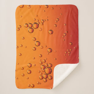 Water droplets on orange surface sherpa blanket