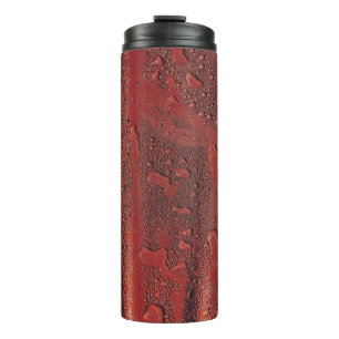 Water drops on red hood thermal tumbler