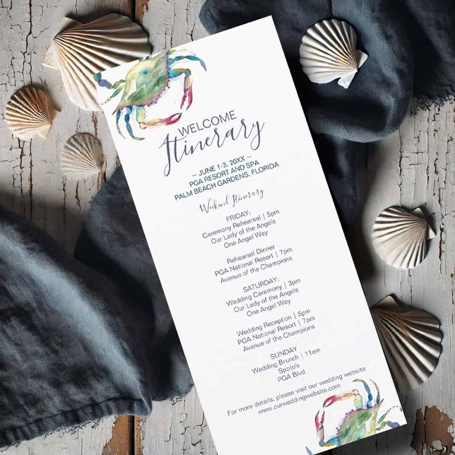 Watercolor Crab Wedding Itinerary (Flat lay of a watercolor crab wedding itinerary card featuring a blue crab illustration)