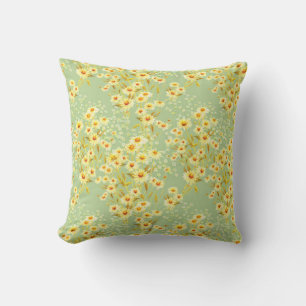 Watercolor picture of daisy flowers on a light gre cushion